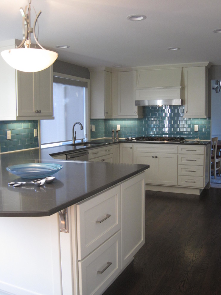 Example of a mid-sized transitional u-shaped dark wood floor open concept kitchen design in Seattle with an undermount sink, shaker cabinets, white cabinets, quartz countertops, blue backsplash, glass tile backsplash, stainless steel appliances and a peninsula