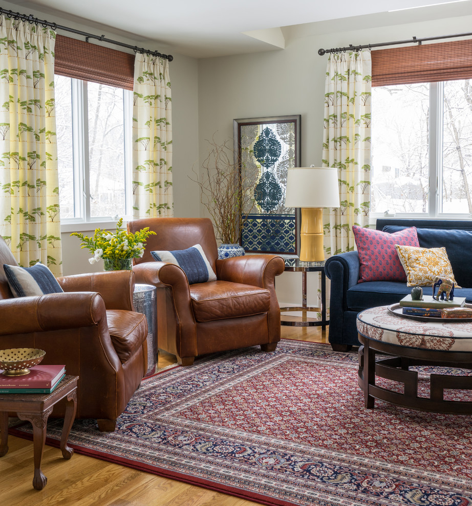 Example of a mid-sized eclectic open concept light wood floor living room design in Boston with gray walls, no fireplace and no tv