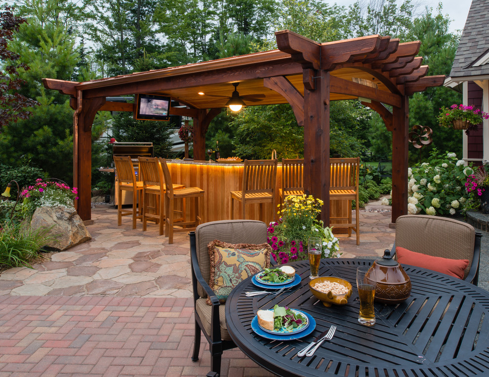 Photo of a mid-sized traditional backyard patio in Other with brick pavers and a gazebo/cabana.