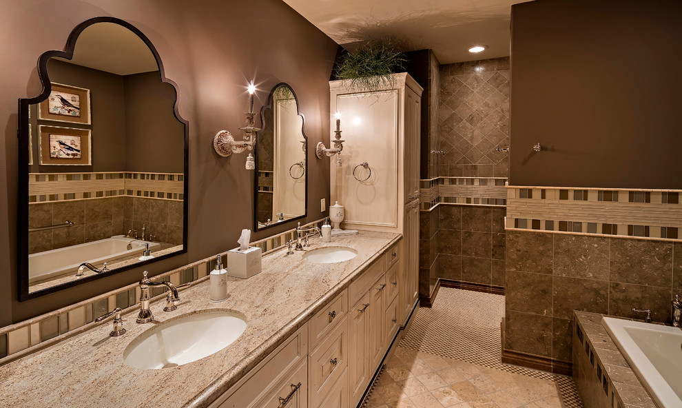 Design ideas for a large transitional master bathroom in Phoenix with raised-panel cabinets, beige cabinets, an open shower, a one-piece toilet, ceramic floors, a drop-in sink, marble benchtops, a corner tub, beige tile, white tile, ceramic tile and brown walls.
