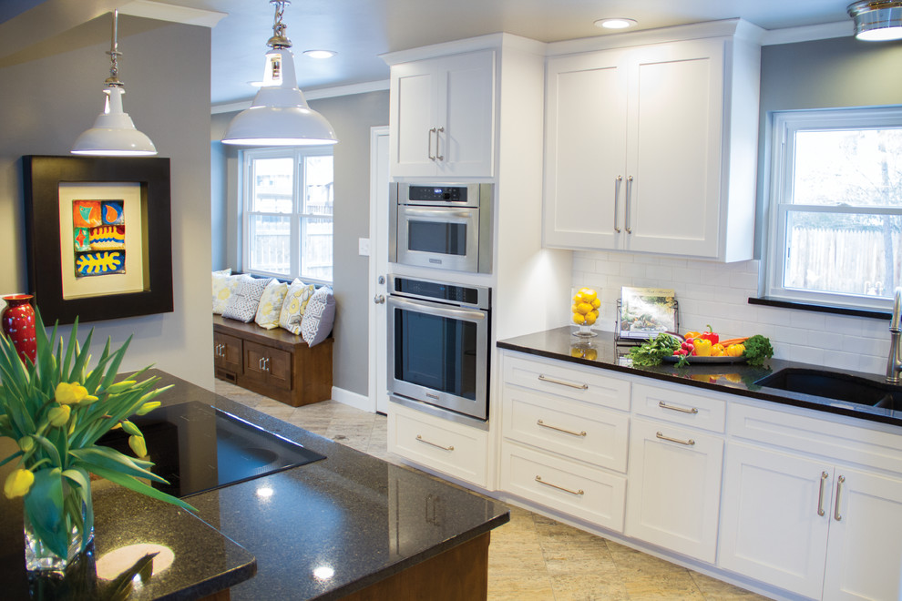 Transitional porcelain tile eat-in kitchen photo with a double-bowl sink, shaker cabinets, white cabinets, granite countertops, white backsplash, subway tile backsplash and stainless steel appliances