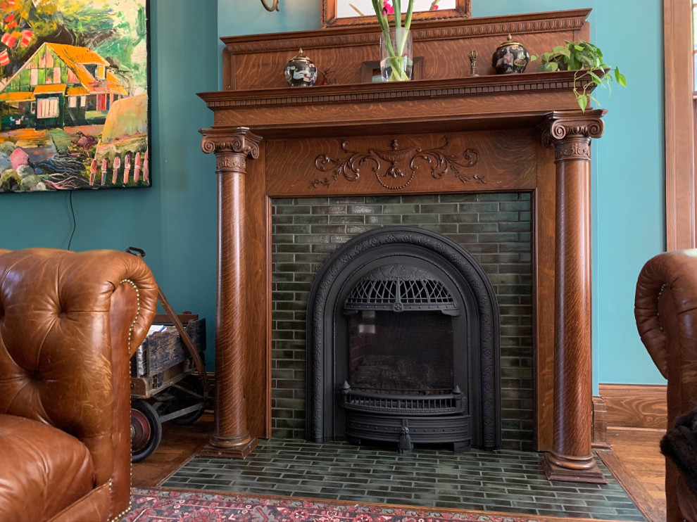 Mid-sized traditional enclosed family room with dark hardwood floors, a standard fireplace, a tile fireplace surround, brown floor and decorative wall panelling.
