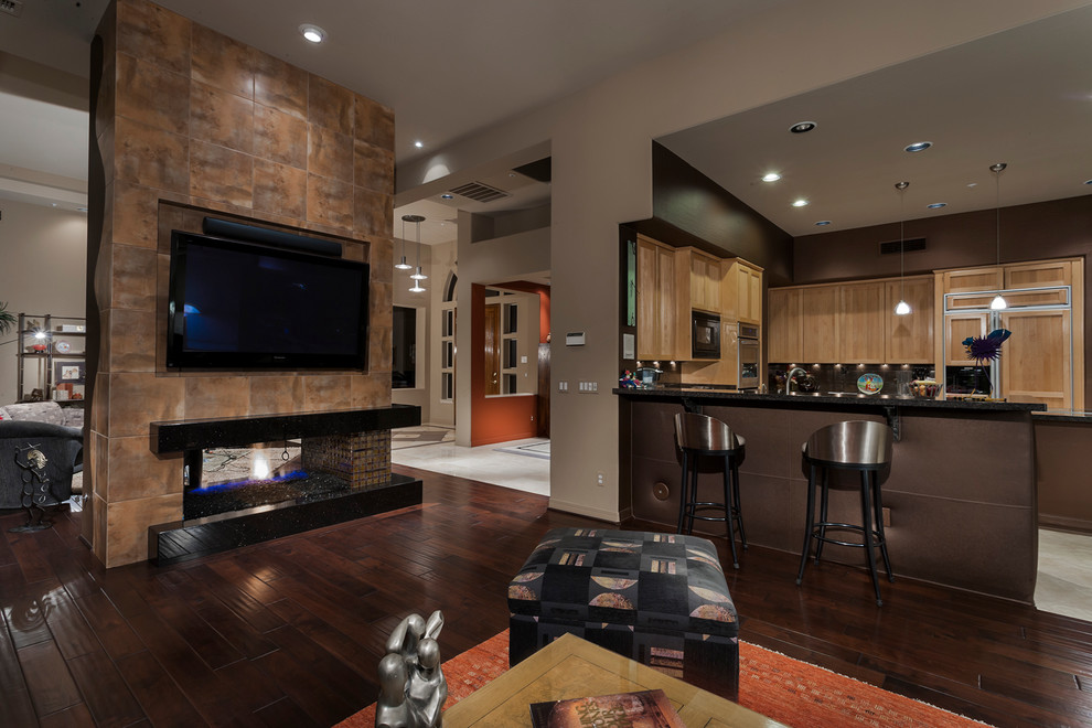 Large contemporary open concept living room in Phoenix with multi-coloured walls, dark hardwood floors, a two-sided fireplace, a tile fireplace surround and a wall-mounted tv.