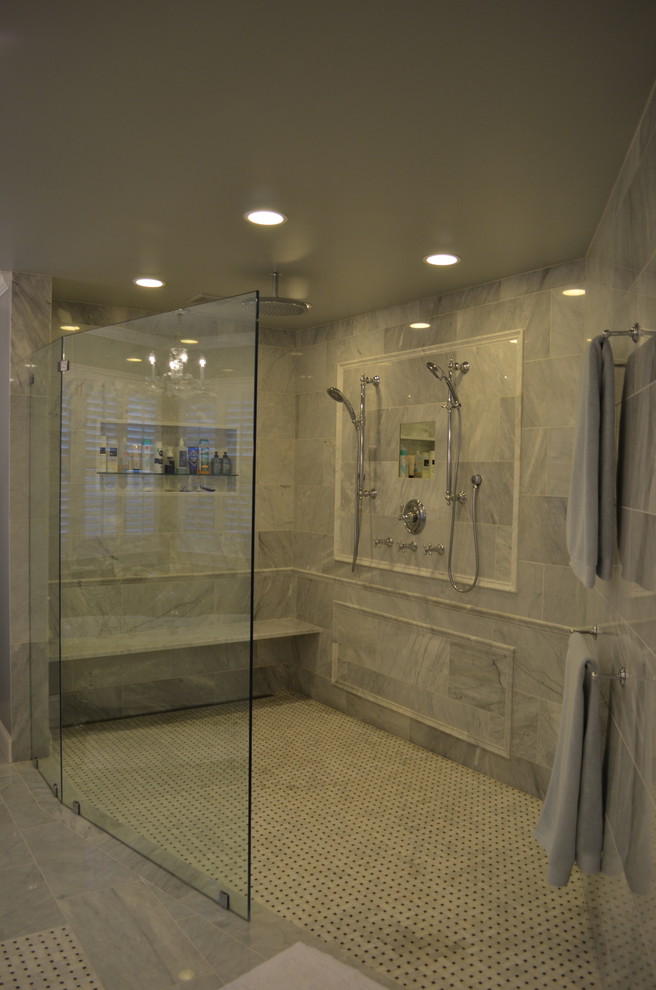 This is an example of a large traditional master bathroom in Philadelphia with raised-panel cabinets, white cabinets, a claw-foot tub, a curbless shower, a two-piece toilet, white tile, stone tile, grey walls, marble floors, an undermount sink and marble benchtops.
