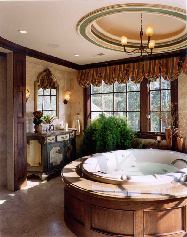 This is an example of an expansive traditional master bathroom in Detroit with furniture-like cabinets, dark wood cabinets, a hot tub, a double shower, a one-piece toilet, beige tile, beige walls, terrazzo floors, a console sink, wood benchtops, beige floor, a hinged shower door and beige benchtops.