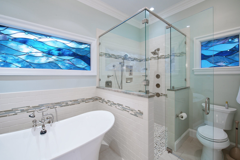 Inspiration for a large transitional master beige tile and subway tile porcelain tile freestanding bathtub remodel with raised-panel cabinets, beige cabinets, blue walls and an undermount sink