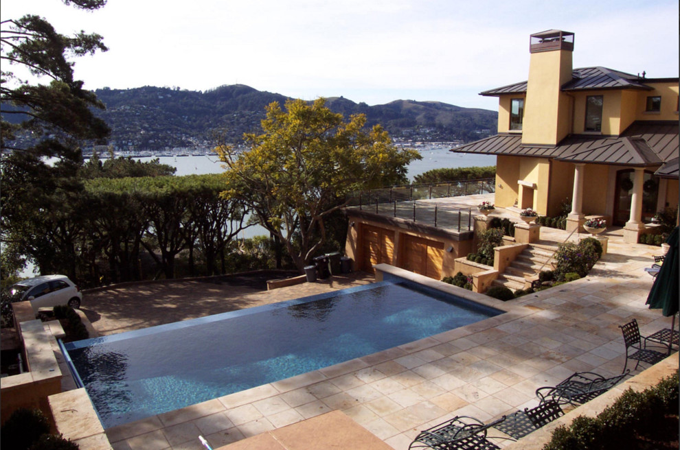 Large mediterranean backyard rectangular infinity pool in San Francisco with a hot tub and tile.
