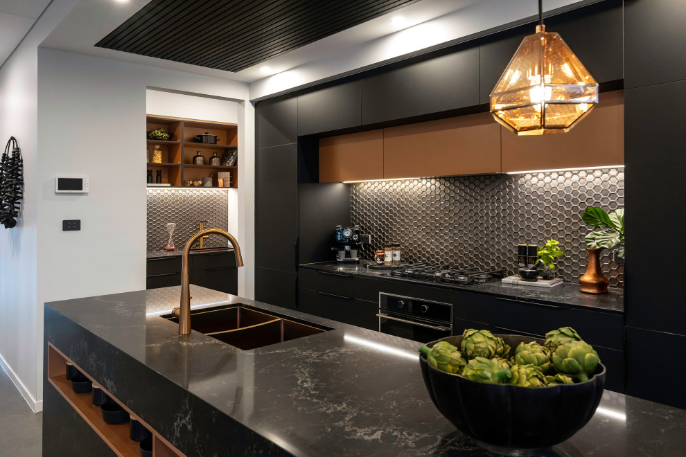 Design ideas for a contemporary galley kitchen in Sydney with an undermount sink, flat-panel cabinets, black cabinets, grey splashback, mosaic tile splashback, black appliances, with island, grey floor and black benchtop.