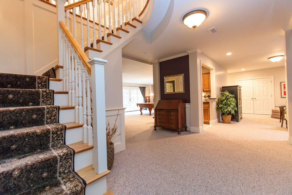 Inspiration for an expansive traditional hallway in Boston with beige walls, carpet and beige floor.