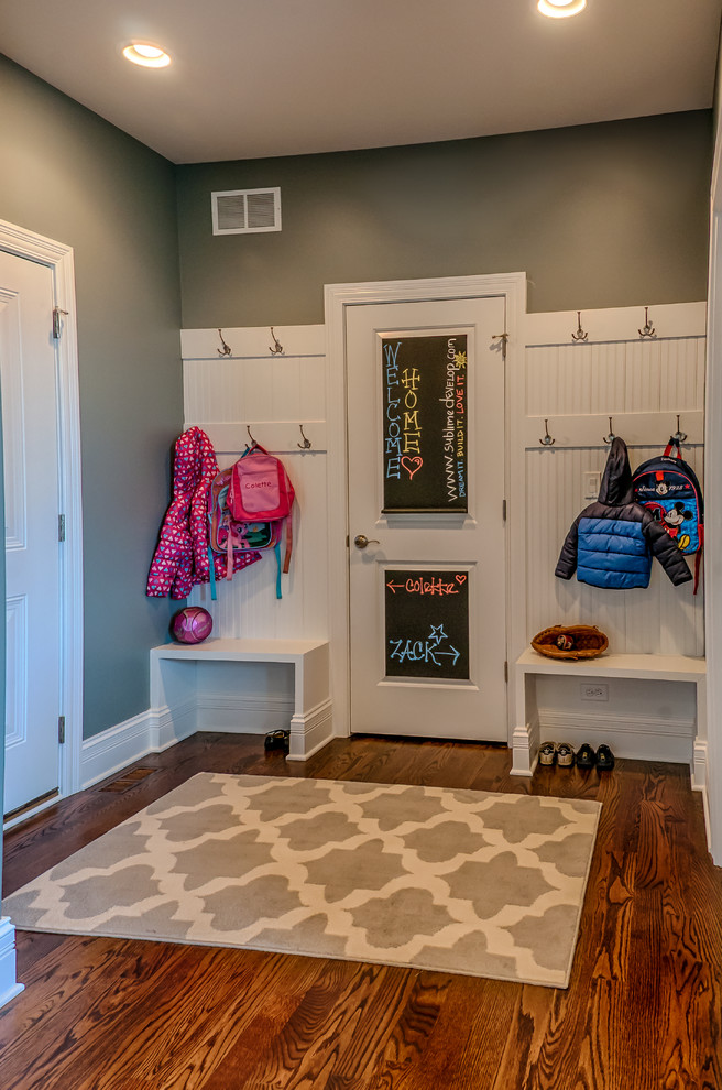 Transitional medium tone wood floor mudroom photo in Chicago with gray walls and a white front door