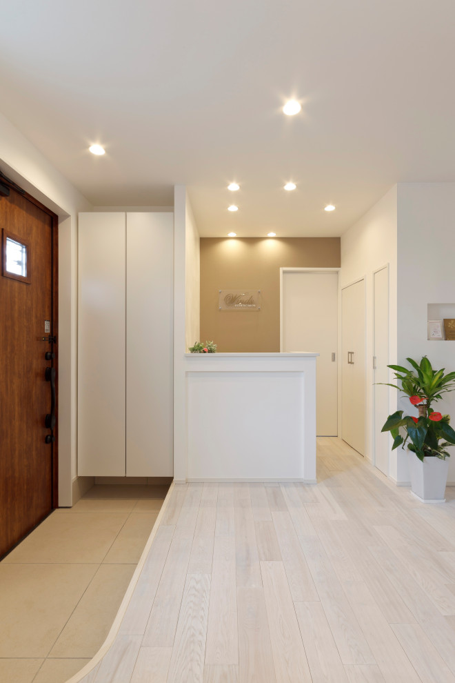 Entry hall in Other with white walls, light hardwood floors, white floor, timber and planked wall panelling.
