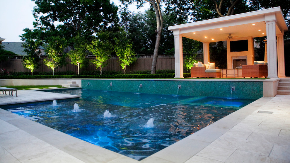 Design ideas for a mid-sized modern backyard l-shaped pool in Dallas with a water feature and natural stone pavers.