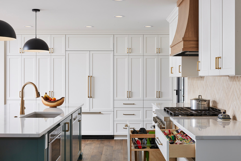This is an example of an expansive contemporary kitchen/diner in Minneapolis with a submerged sink, flat-panel cabinets, white cabinets, engineered stone countertops, beige splashback, cement tile splashback, stainless steel appliances, an island and white worktops.