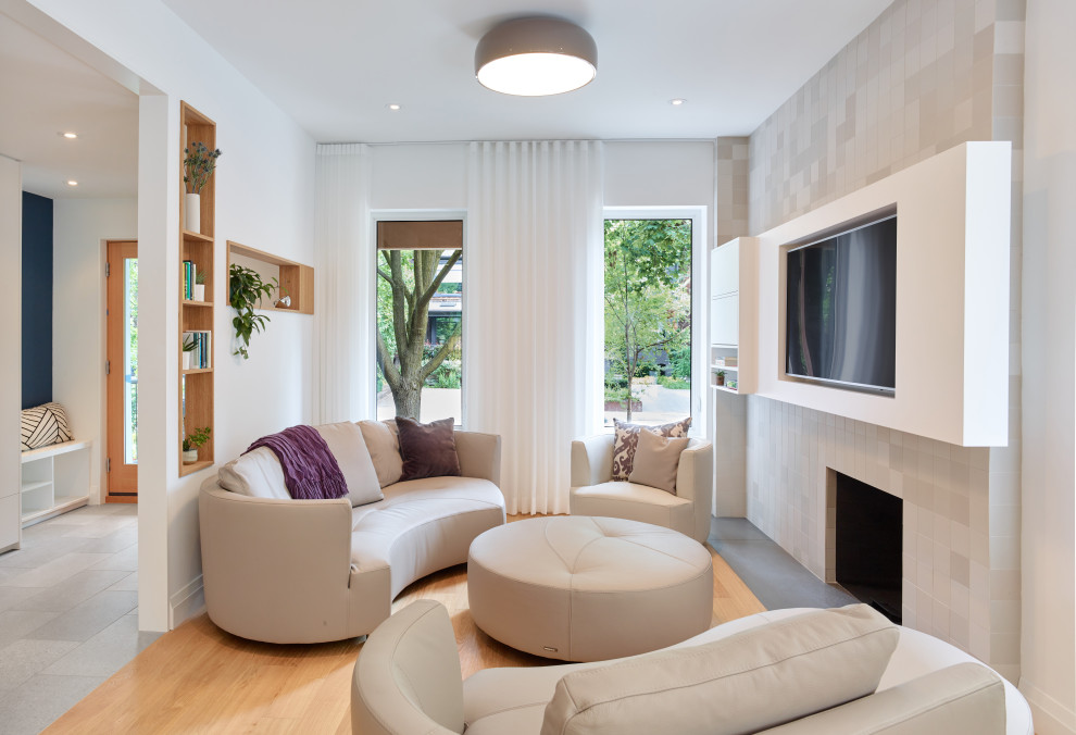 Foto di un soggiorno minimalista di medie dimensioni e chiuso con sala formale, pareti bianche, parquet chiaro, camino classico, parete attrezzata e pavimento giallo