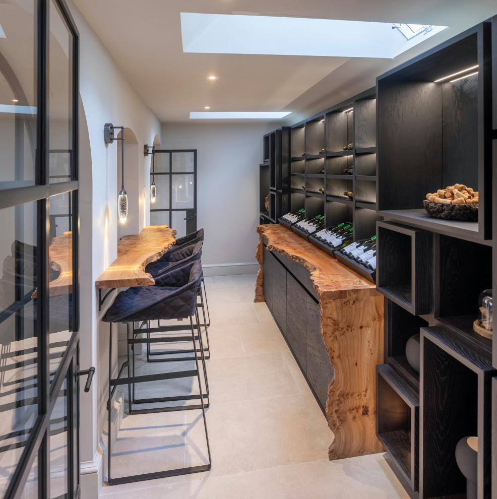 Large contemporary wine cellar in West Midlands with ceramic floors, display racks and white floor.