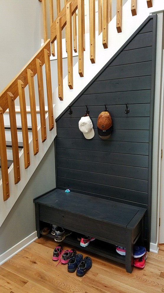 Transitional light wood floor foyer photo with gray walls