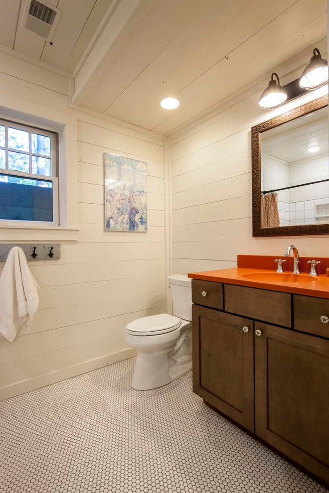 This is an example of an eclectic bathroom in Other with shaker cabinets, medium wood cabinets, a curbless shower, a two-piece toilet, white tile, ceramic tile, white walls, ceramic floors, an integrated sink, concrete benchtops, white floor and a shower curtain.