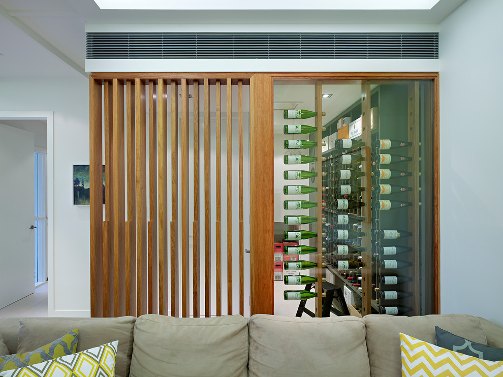 Photo of a contemporary wine cellar in Brisbane with display racks.