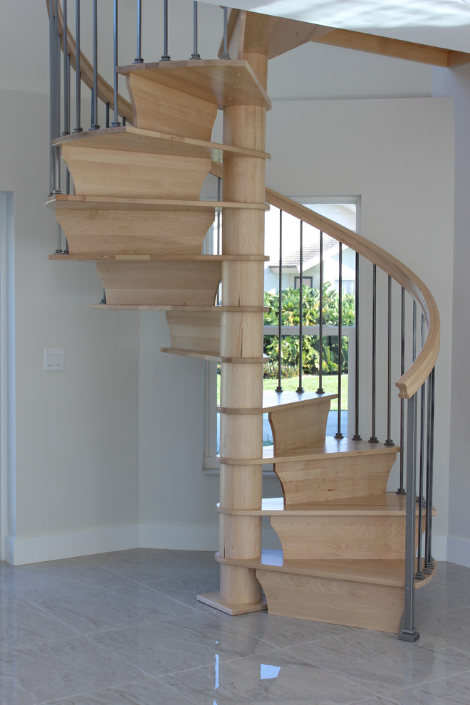 Small transitional wood spiral staircase in Other with wood risers and mixed railing.