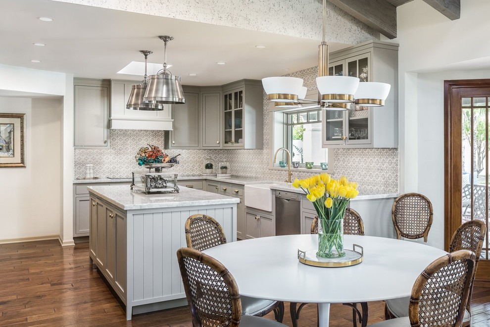 Traditional l-shaped eat-in kitchen in Phoenix with a farmhouse sink, shaker cabinets, grey cabinets, grey splashback, stainless steel appliances, dark hardwood floors, with island and brown floor.