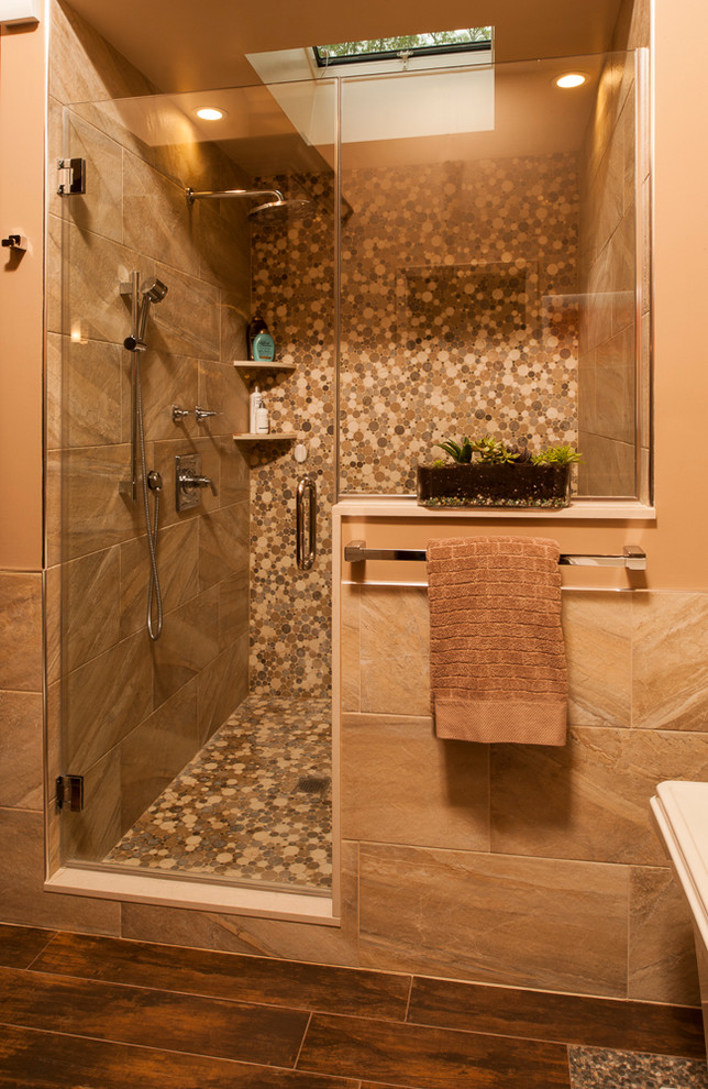 This is an example of a large asian master bathroom in New York with flat-panel cabinets, medium wood cabinets, engineered quartz benchtops, a freestanding tub, an alcove shower, porcelain tile, brown walls, porcelain floors, a vessel sink, brown floor and a hinged shower door.