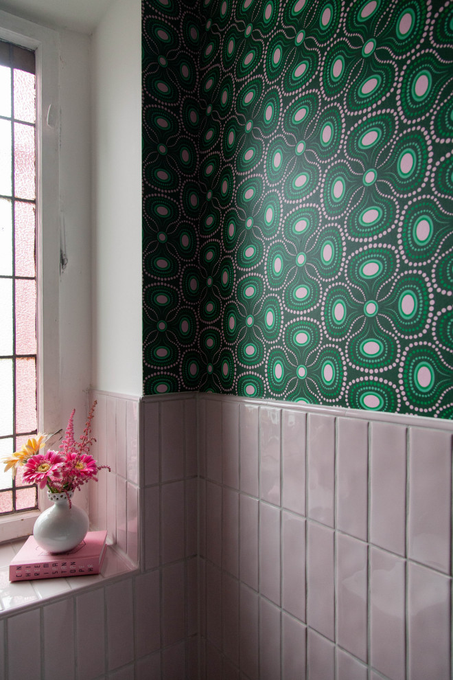 Inspiration for a small eclectic master pink tile and ceramic tile ceramic tile, pink floor, single-sink and wallpaper toilet room remodel in Berlin with flat-panel cabinets, gray cabinets, a one-piece toilet, green walls, an integrated sink, laminate countertops, white countertops and a floating vanity