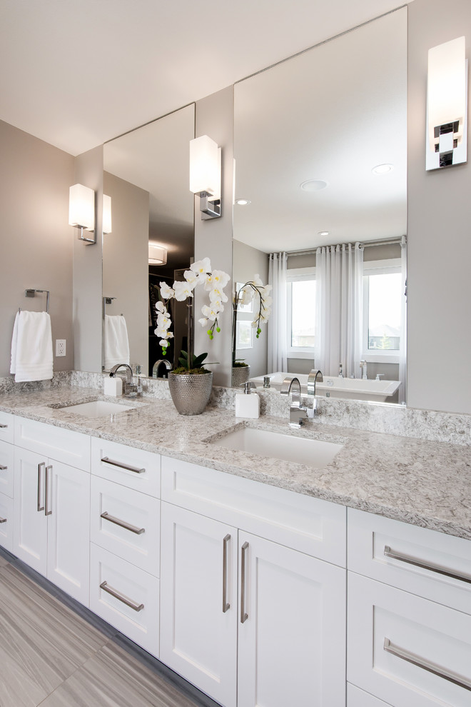 This is an example of a large contemporary master bathroom in Other with shaker cabinets, white cabinets, quartzite benchtops and a freestanding tub.