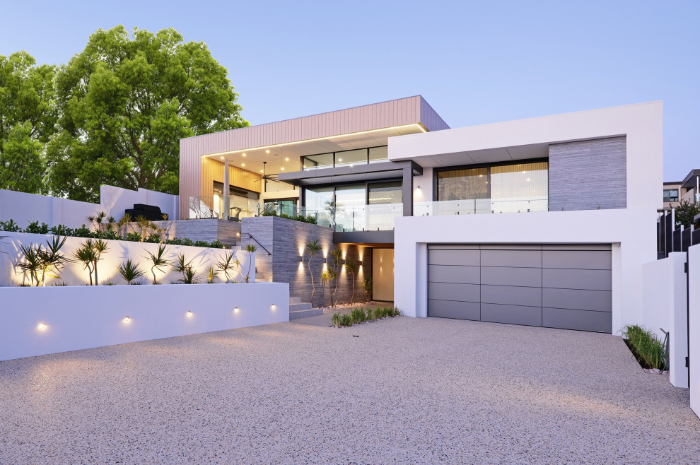 Inspiration for a mid-sized contemporary two-storey house exterior in Perth with a flat roof and a metal roof.