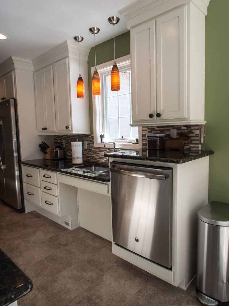 Large transitional u-shaped porcelain tile eat-in kitchen photo with an undermount sink, recessed-panel cabinets, white cabinets, granite countertops, multicolored backsplash, glass tile backsplash, stainless steel appliances and an island