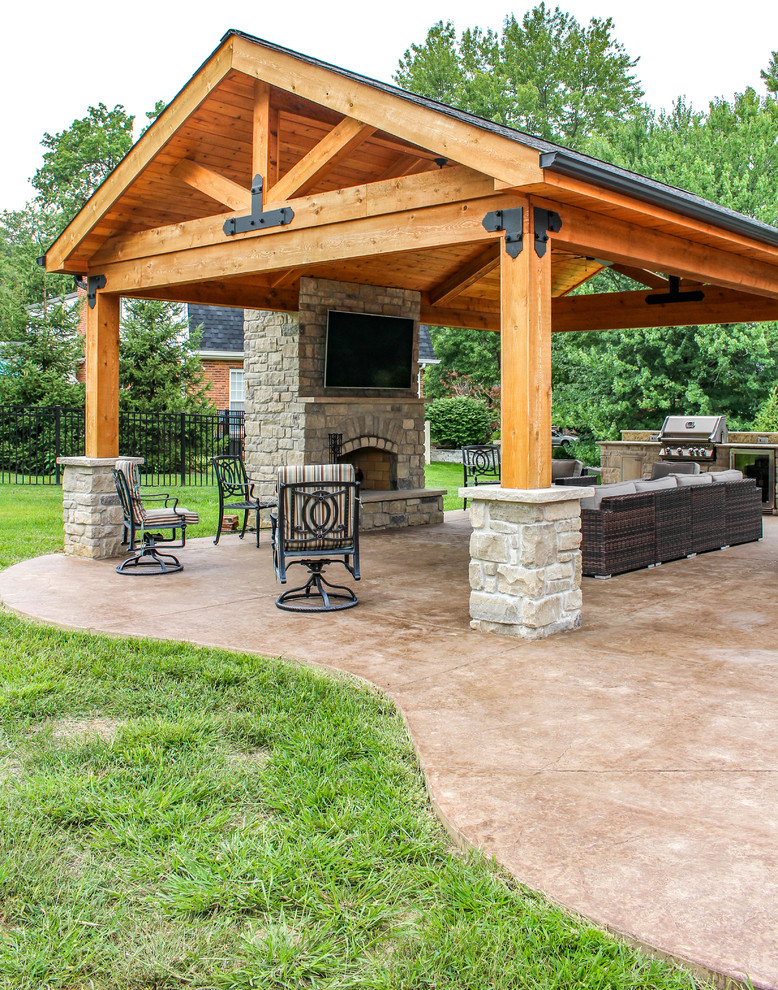 This is an example of a mid-sized backyard patio in St Louis with an outdoor kitchen, stamped concrete and a gazebo/cabana.