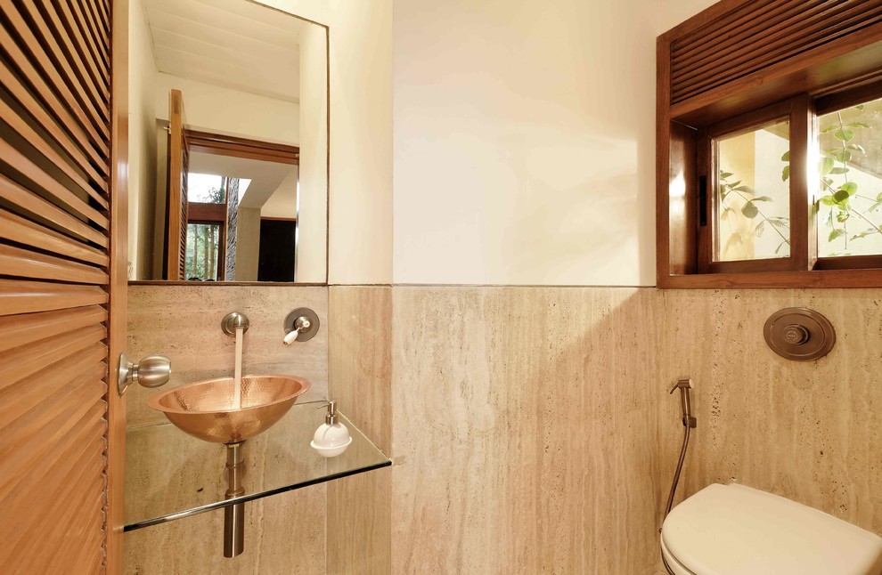 Photo of a contemporary powder room in Bengaluru with travertine.