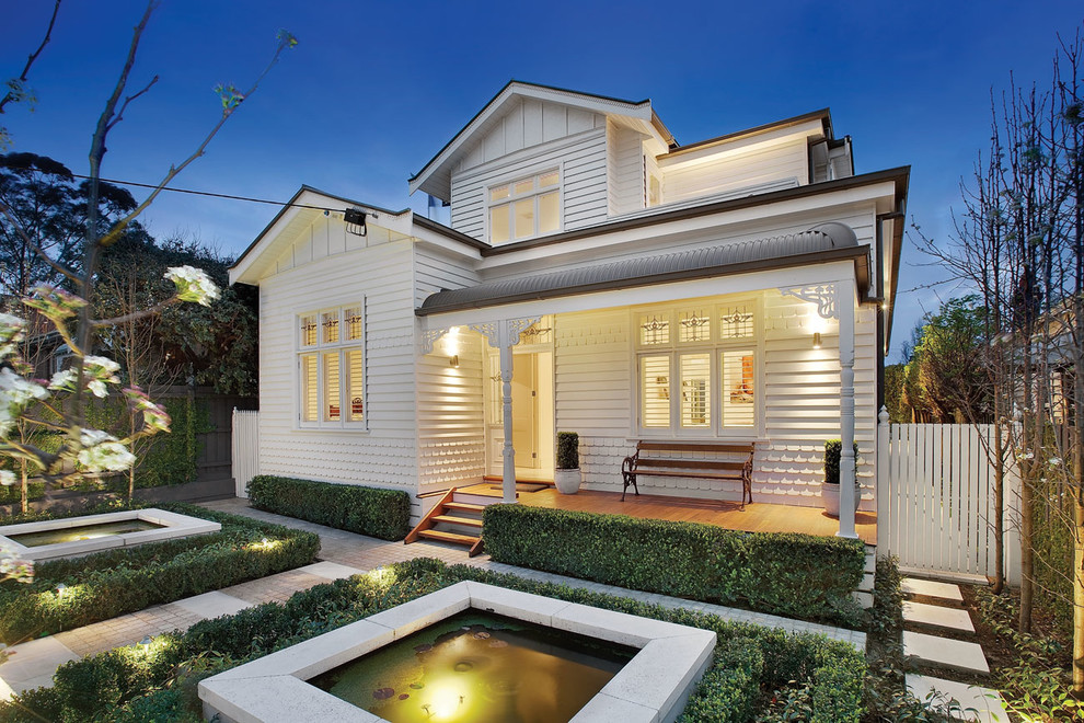 Photo of a traditional two-storey white exterior in Melbourne with wood siding.