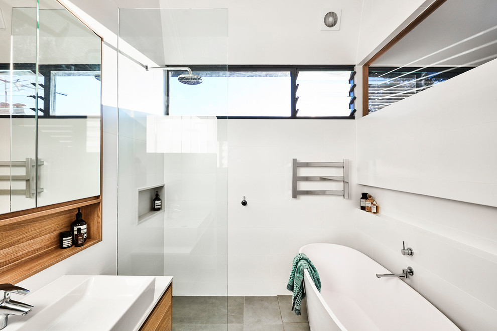 Inspiration for a large contemporary kids bathroom in Sydney with a drop-in tub, an open shower, a one-piece toilet, white tile, ceramic tile, white walls, ceramic floors, an undermount sink, grey floor and an open shower.
