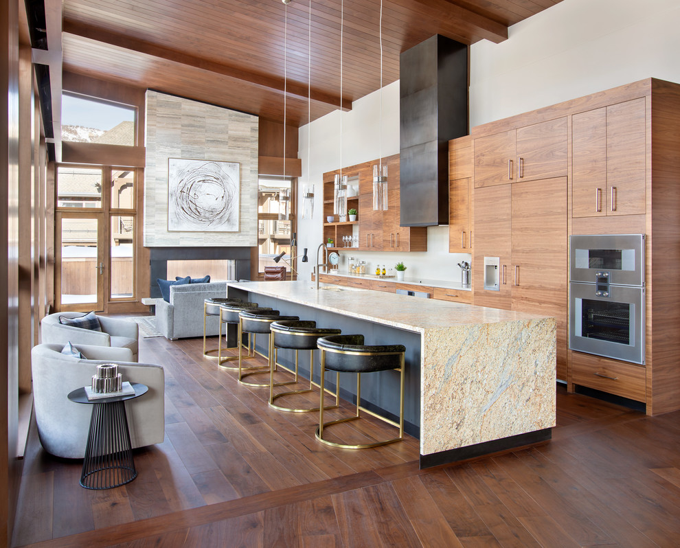 This is an example of a country open plan kitchen in Denver with an undermount sink, flat-panel cabinets, medium wood cabinets, white splashback, dark hardwood floors, with island, brown floor and multi-coloured benchtop.