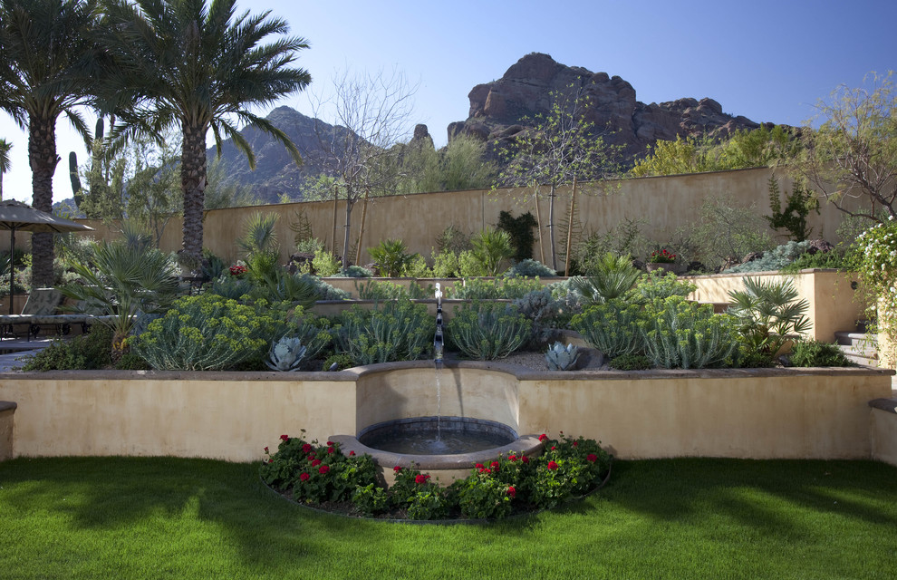 Inspiration for a mediterranean garden in Phoenix with a retaining wall.