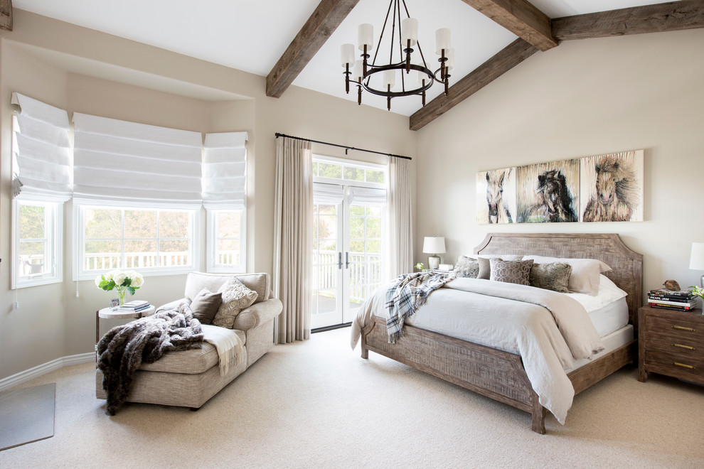Design ideas for a mid-sized country master bedroom in Los Angeles with beige walls, carpet, a two-sided fireplace and a stone fireplace surround.
