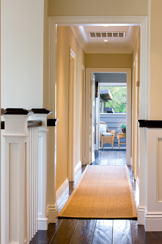 Mid-sized transitional hallway in San Francisco with beige walls and dark hardwood floors.