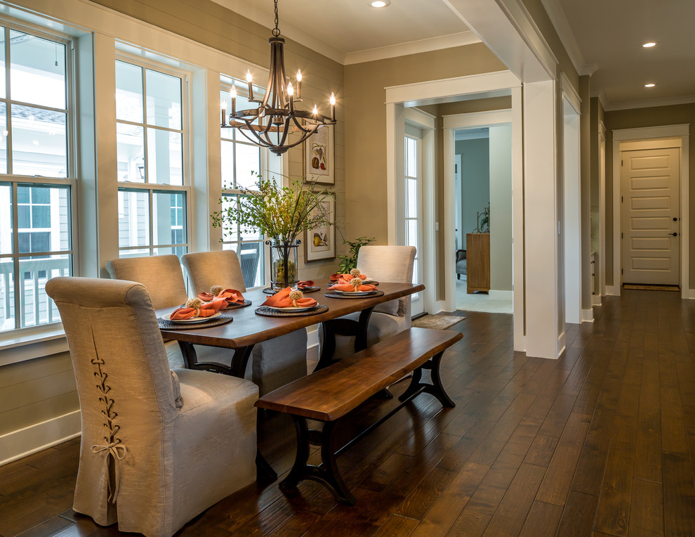 This is an example of a mid-sized country dining room in Miami with brown walls, no fireplace and dark hardwood floors.