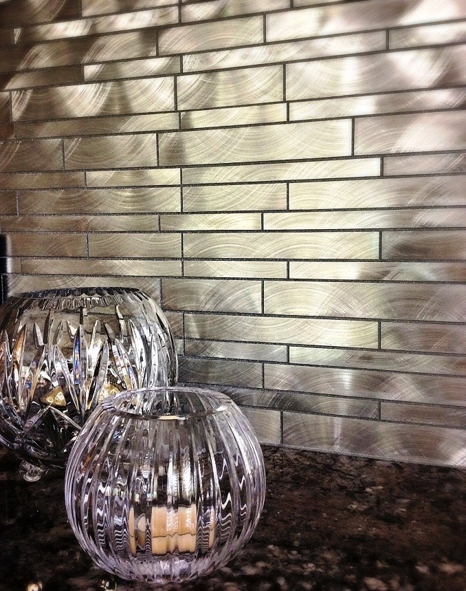 Eat-in kitchen - mid-sized transitional l-shaped travertine floor eat-in kitchen idea in Houston with a farmhouse sink, raised-panel cabinets, white cabinets, granite countertops, metallic backsplash, metal backsplash, stainless steel appliances and an island