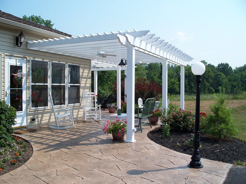 Inspiration for a large eclectic backyard patio in Nashville with stamped concrete and a pergola.