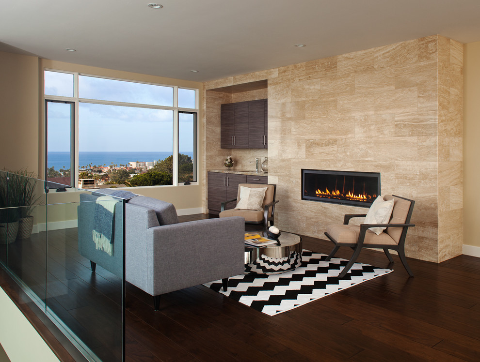This is an example of a mid-sized contemporary loft-style living room in San Diego with a home bar, beige walls, dark hardwood floors, a ribbon fireplace and a stone fireplace surround.