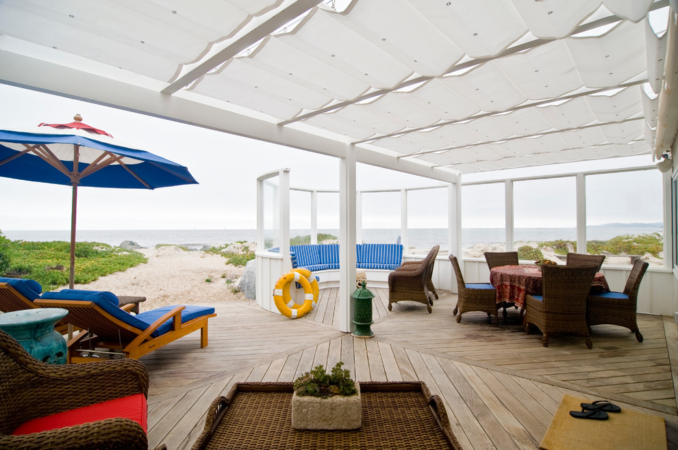 Beach style backyard deck in Los Angeles with an awning.
