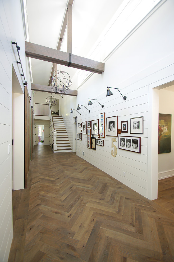 Photo of a large country hallway in San Francisco with white walls, medium hardwood floors and brown floor.