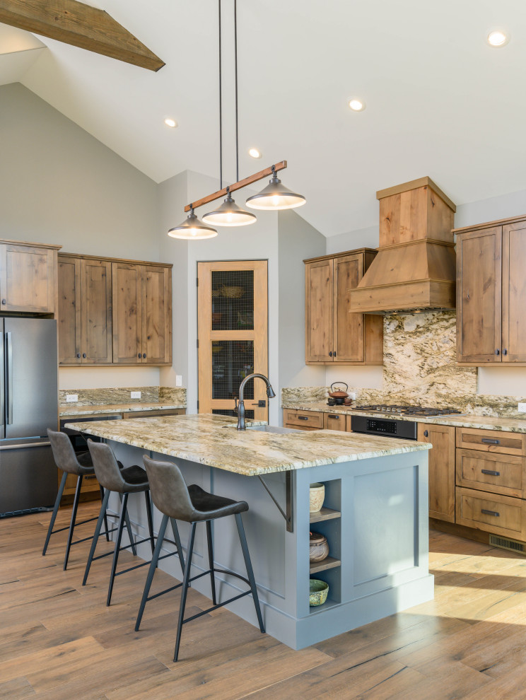 Eat-in kitchen - transitional l-shaped medium tone wood floor and brown floor eat-in kitchen idea with an undermount sink, shaker cabinets, medium tone wood cabinets, multicolored backsplash, stone slab backsplash, stainless steel appliances, an island and multicolored countertops