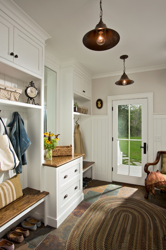 Example of a cottage entryway design in Boston with a glass front door and white walls