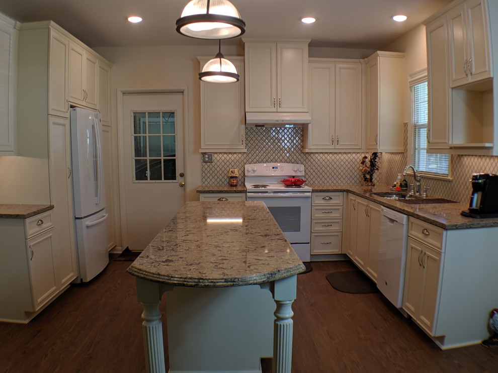 Mid-sized arts and crafts u-shaped vinyl floor and brown floor eat-in kitchen photo with an undermount sink, beige cabinets, granite countertops, beige backsplash, mosaic tile backsplash, white appliances and an island