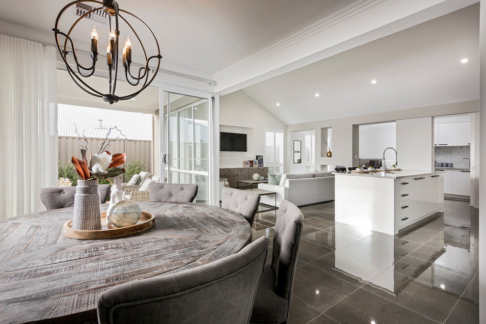 This is an example of a Large transitional Open Concept living room in Perth With White Walls, Porcelain Floors, a Two-sided Fireplace, a Concrete Fireplace Surround, a Wall-mounted TV and Grey Floor.