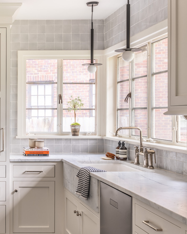 Eat-in kitchen - mid-sized transitional l-shaped cement tile floor and gray floor eat-in kitchen idea with a drop-in sink, shaker cabinets, white cabinets, quartzite countertops, gray backsplash, porcelain backsplash, stainless steel appliances, an island and multicolored countertops