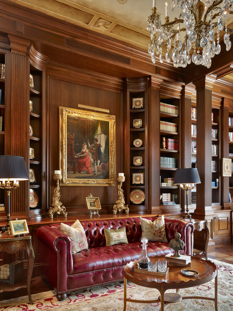 This is an example of a traditional study room in Miami with dark hardwood floors.