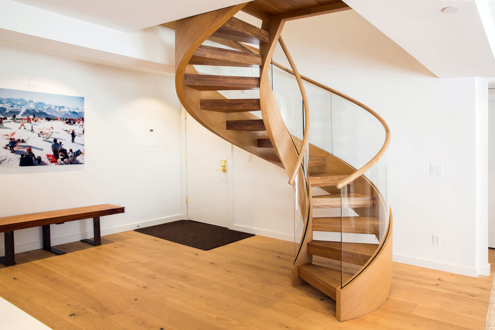 Photo of a mid-sized scandinavian wood curved staircase in Other with open risers.